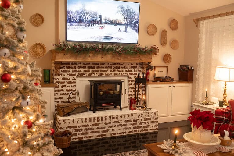 The fireplace setup with a close-up on its cozy and inviting Christmas decor, paired with stockings and a flickering glow.
