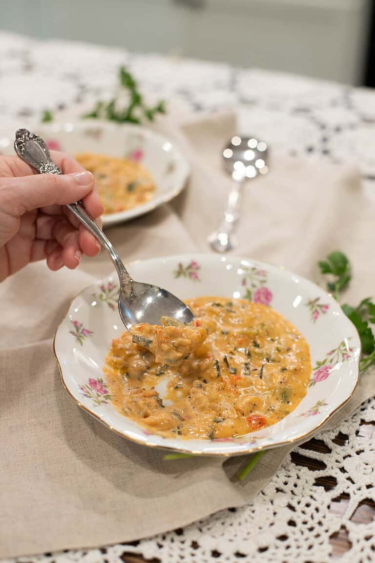 A final close-up of a spoonful of étouffée lifted above the bowl, emphasizing its rich and creamy texture.
