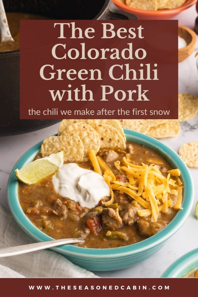 Colorado pork green chili served with sourcream, cheese, chips and lime image for pinterest. Made in a Smithey Dutch oven.