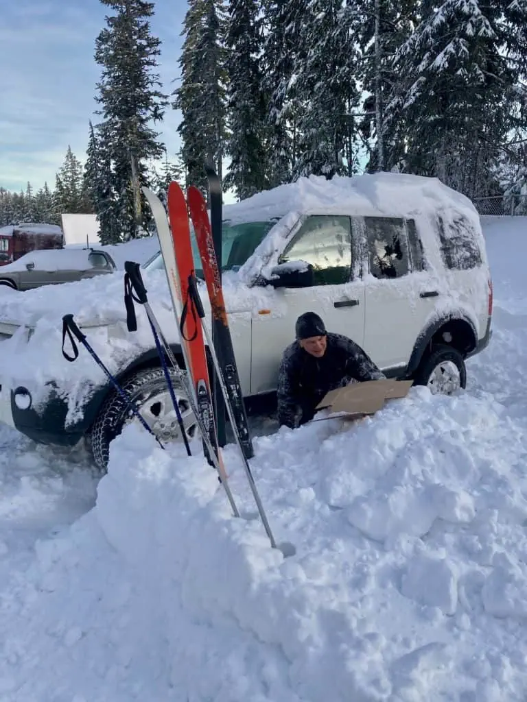 Digging the car out of the snow after skiing out to it.