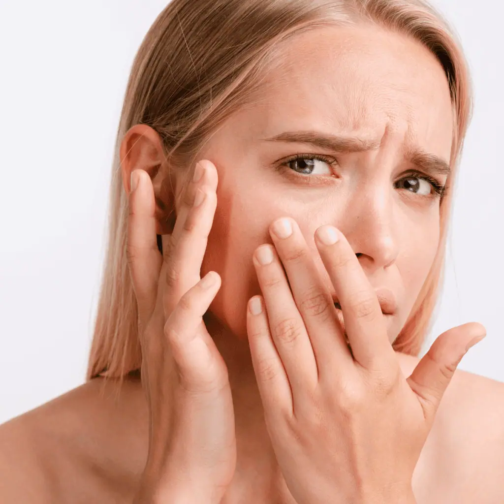 up close shot of worried woman touching her face