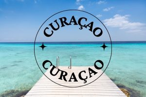 the words curacao as a destination and a blue ocean with a dock