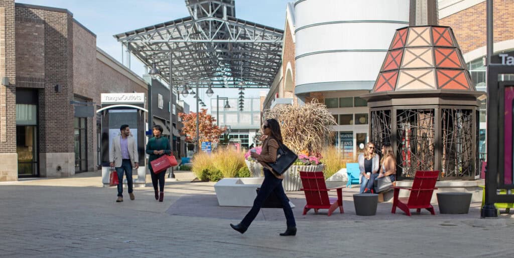 Modern shopping plaza with outdoor seating and landscaping for urban aesthetic, featuring Thornapple Painting services for commercial exteriors.