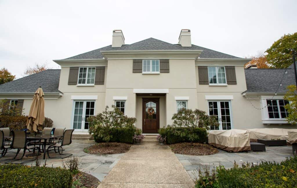 Elegant exterior of Thornapple Painting's residential home with freshly painted shutters and trim in a modern, stylish house.