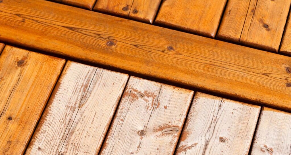 Weathered wood decking with a mix of stained and painted wooden planks, showcasing natural textures and colors, ideal for siding, flooring, or outdoor patio projects. Perfect for enhancing home aesthetic appeal.