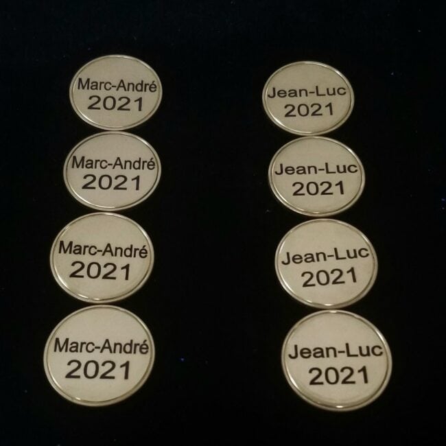 Silver engraved coffee tokens featuring names "Marc-André" and "Jean-Luc" with the year 2021. Perfect for personalized commemorative gifts.