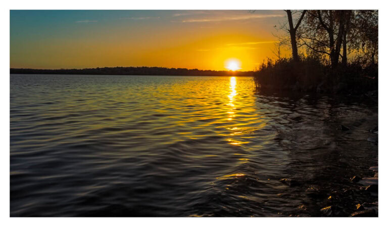 Sun touching the shore of Onondaga Lake.