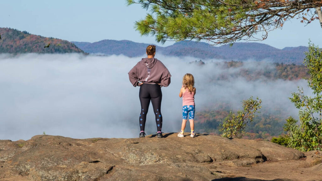 mother and daughter looking at an inversion on mountain top