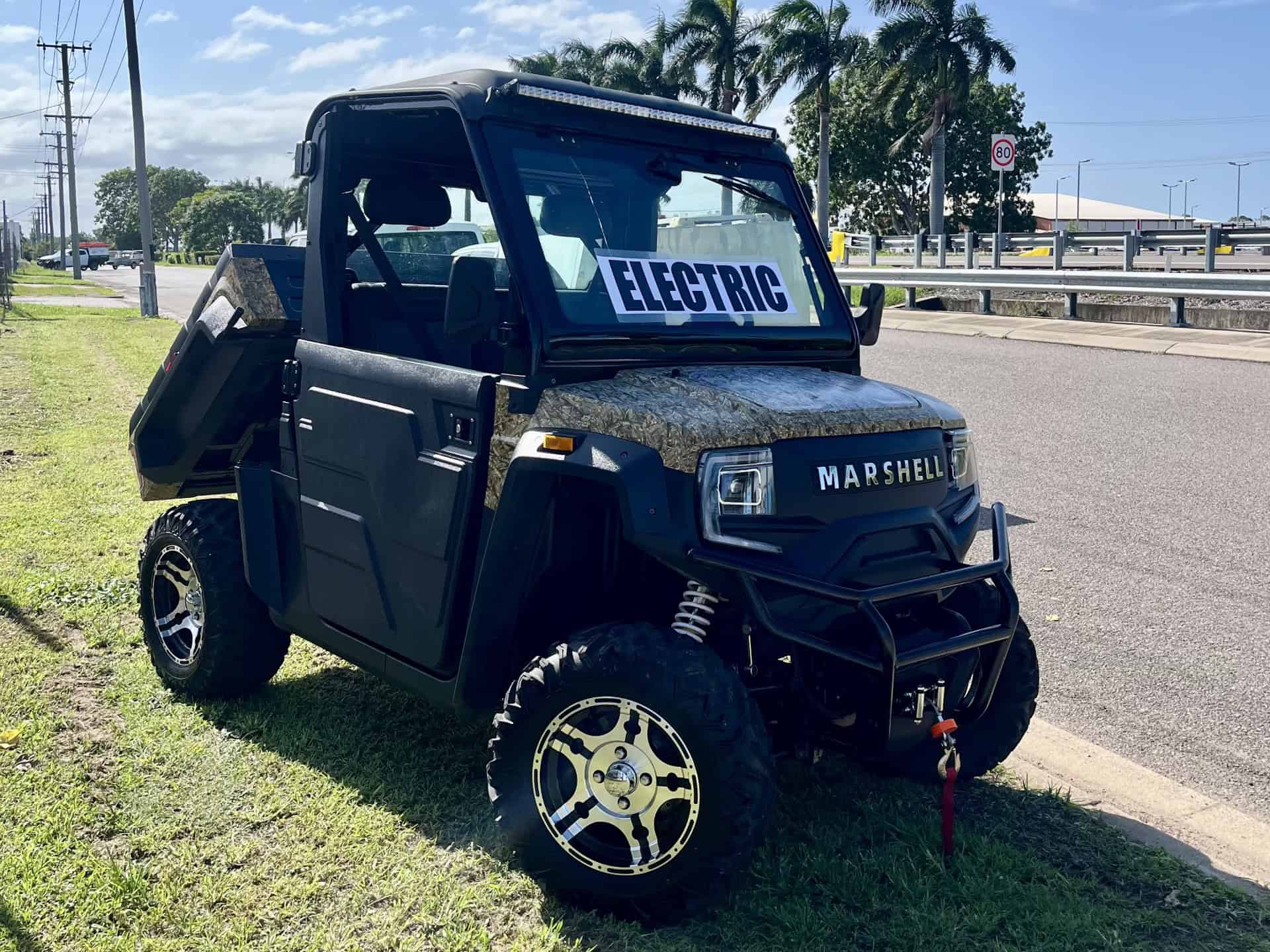 Electric utility vehicle with off-road tires and Marshell branding.
