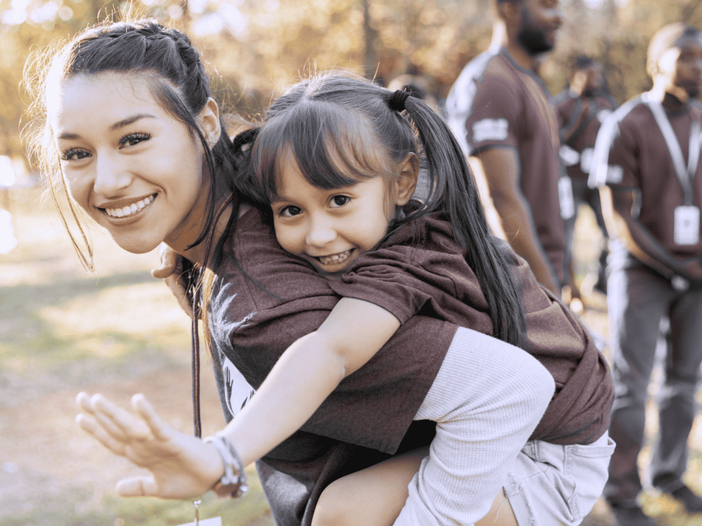 Woman with child piggyback.
