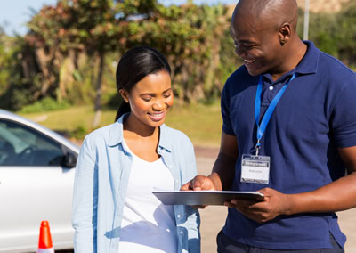 Instructor teaching student in drivers ed course