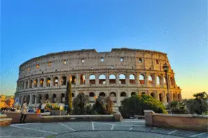 Exterior view of the Colosseum in Rome at sunset, captured from outside the walls