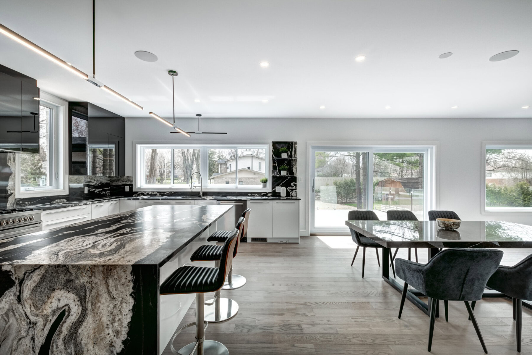 Modern kitchen with black and white marble island and dining table