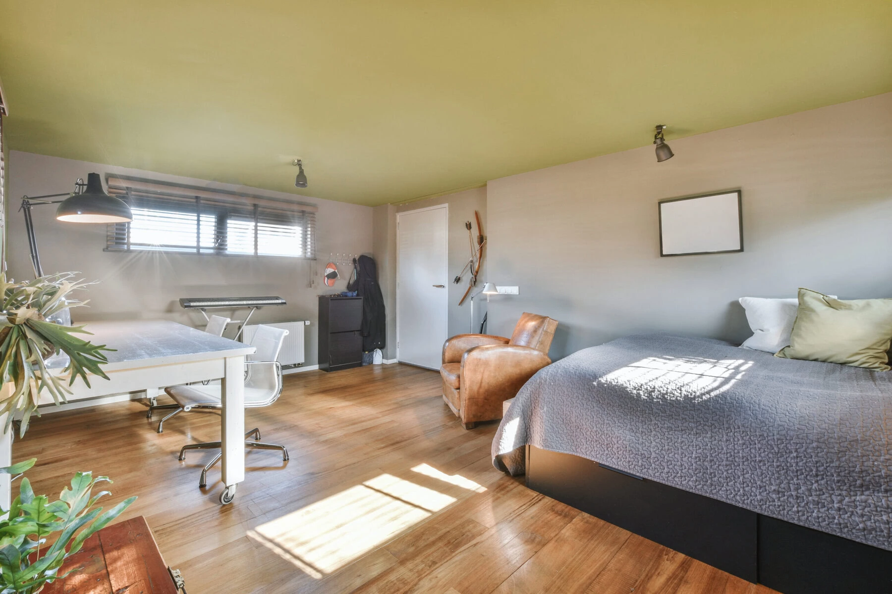 Bedroom with a bed, a desk, a chair, and a window