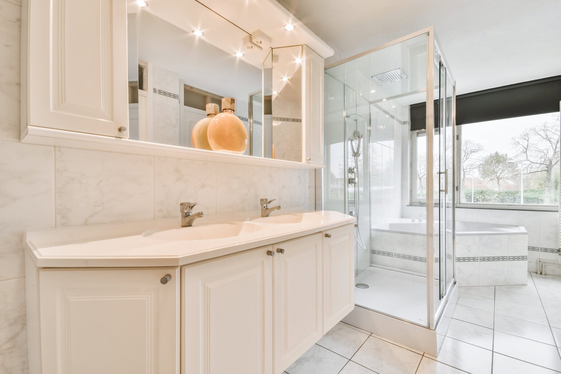 Modern bathroom with double vanity, shower, and bathtub