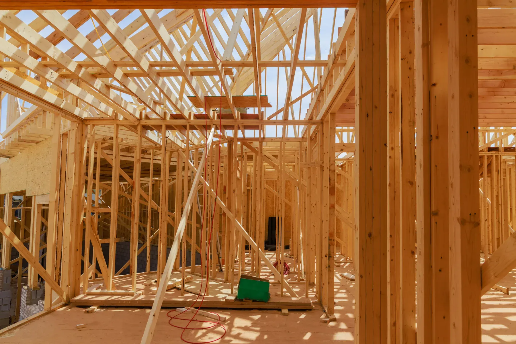 Interior view of a house under construction with exposed wooden framing
