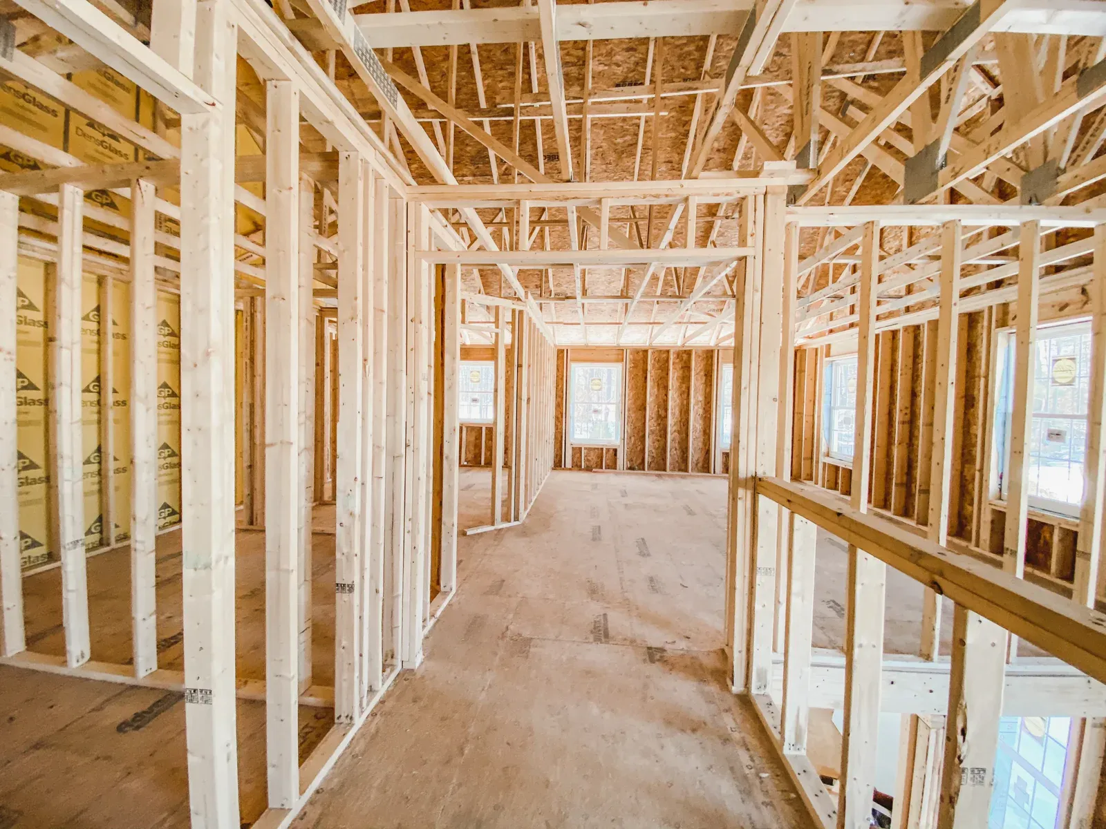 Interior view of a house under construction with exposed wooden framing