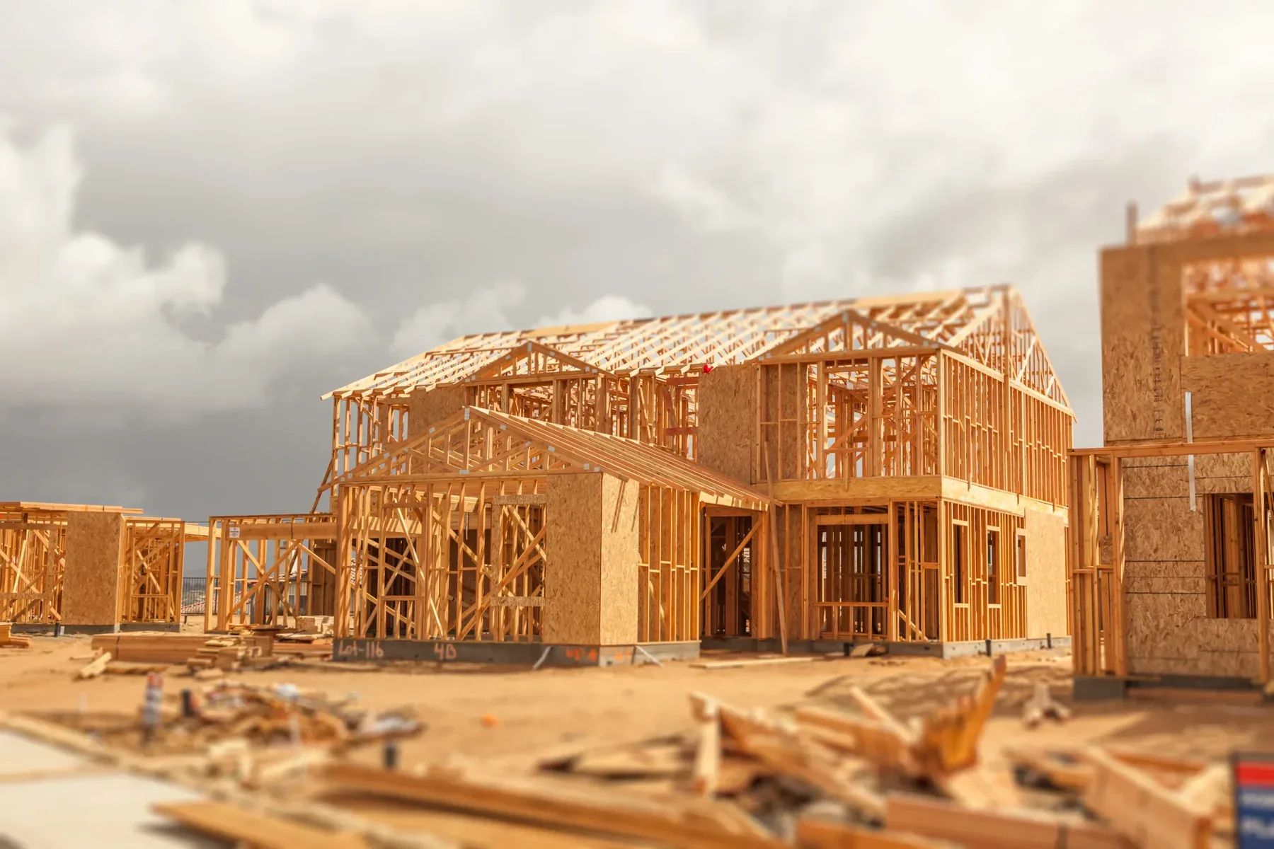 New house under construction with wooden framing and plywood sheathing.