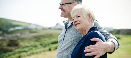 elderly couple hugging on hillside; types of trusts