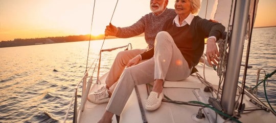 elderly couple saling on boat in sunset; types of trusts