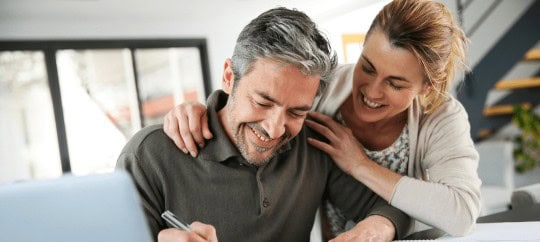 Man Woman Smiles And He Signs A Document