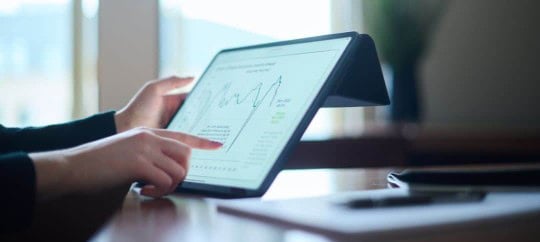 Person looking at graph on tablet