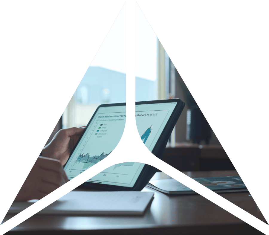 triangle shape over image of tablet being held with graph on it