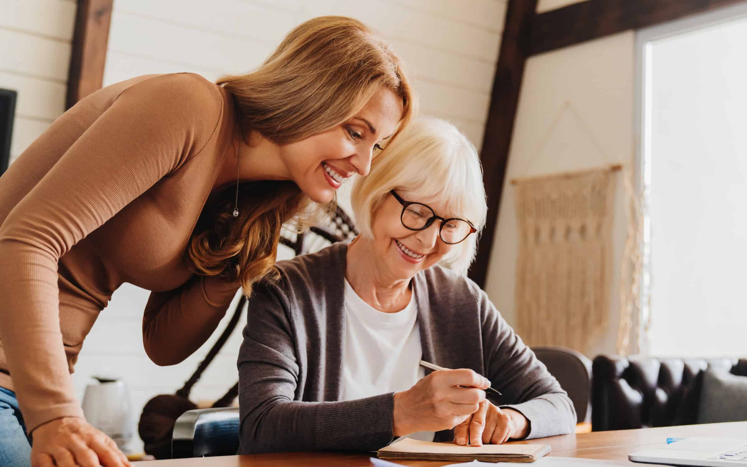 Two women looking at notebook