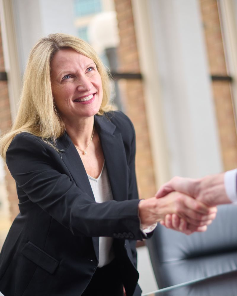 Business professional shaking a client's hand