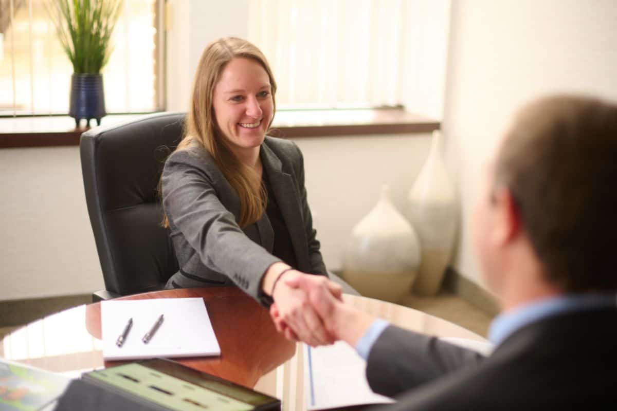 Business-woman shaking hands with a client