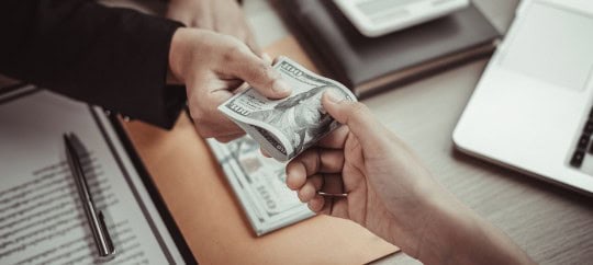 two people handling money