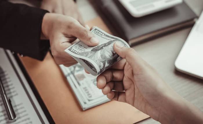 two people handling money