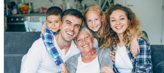 Generations of family smiling at the camera