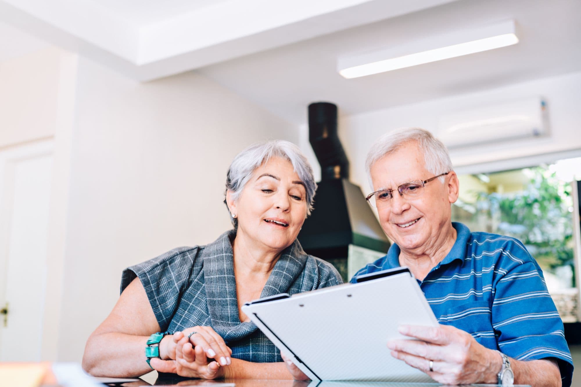 Elderly Man and Woman looking at paperwork