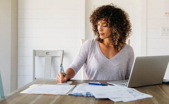 Women writing on financial documents