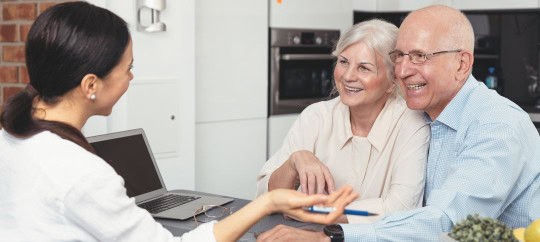 Man and Women working with an estate planner on a computer