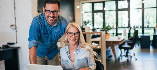 Business owners smiling with laptop