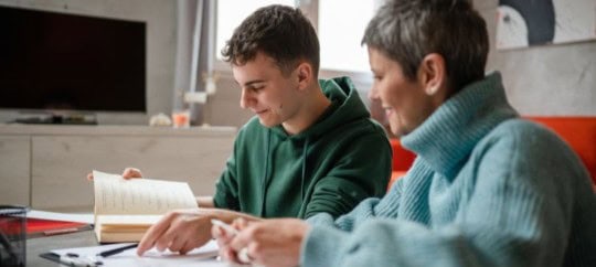 Mother and son looking at a book