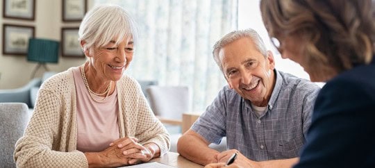 retired man and woman speaking with financial professional