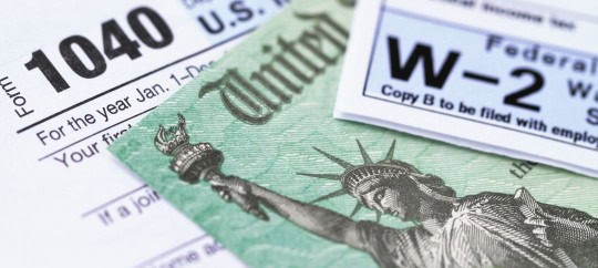 Image of tax forms and the statue of liberty
