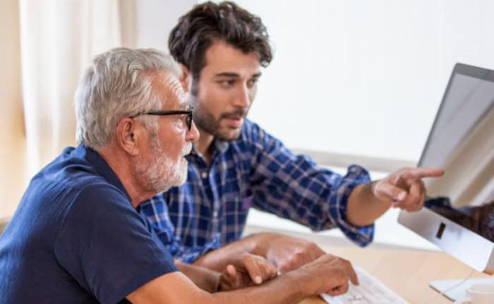 Retired Man and son looking at computer