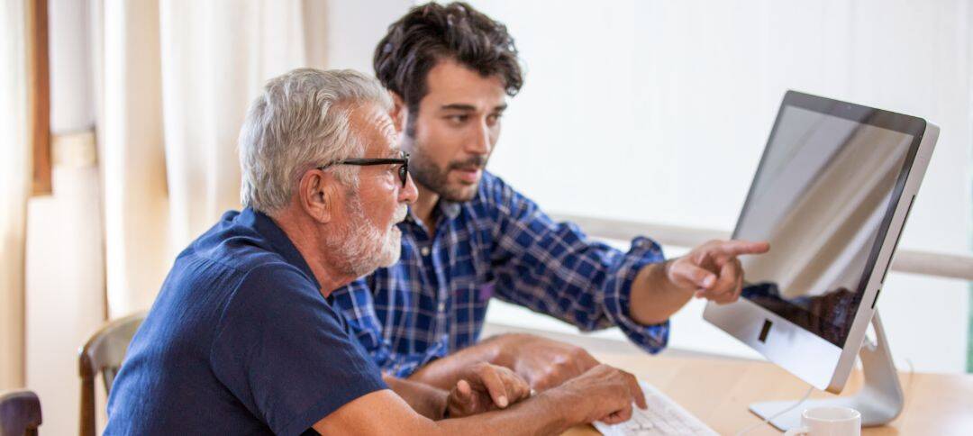 Retired Man and son looking at computer
