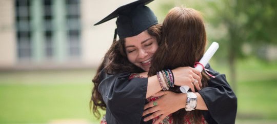 College grad hugging her mother