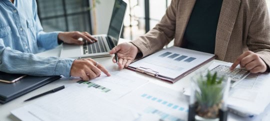 2 people looking at paperwork for tax planning