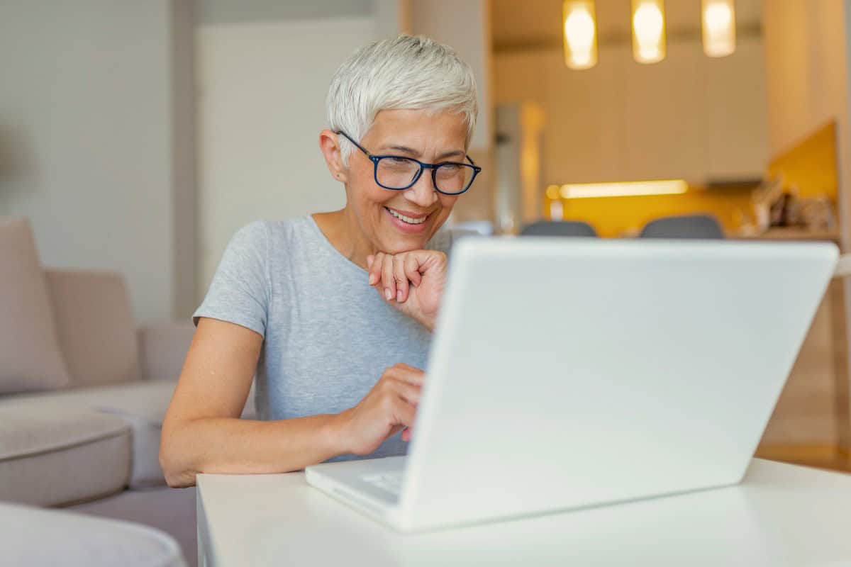 Woman smiling at laptop