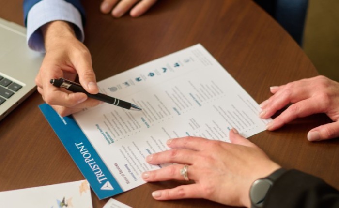 Trust Point team members reviewing the menu of services