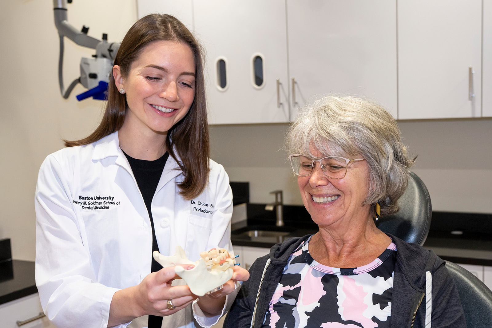 Dr. Boucher showing a patient a dental teeth model