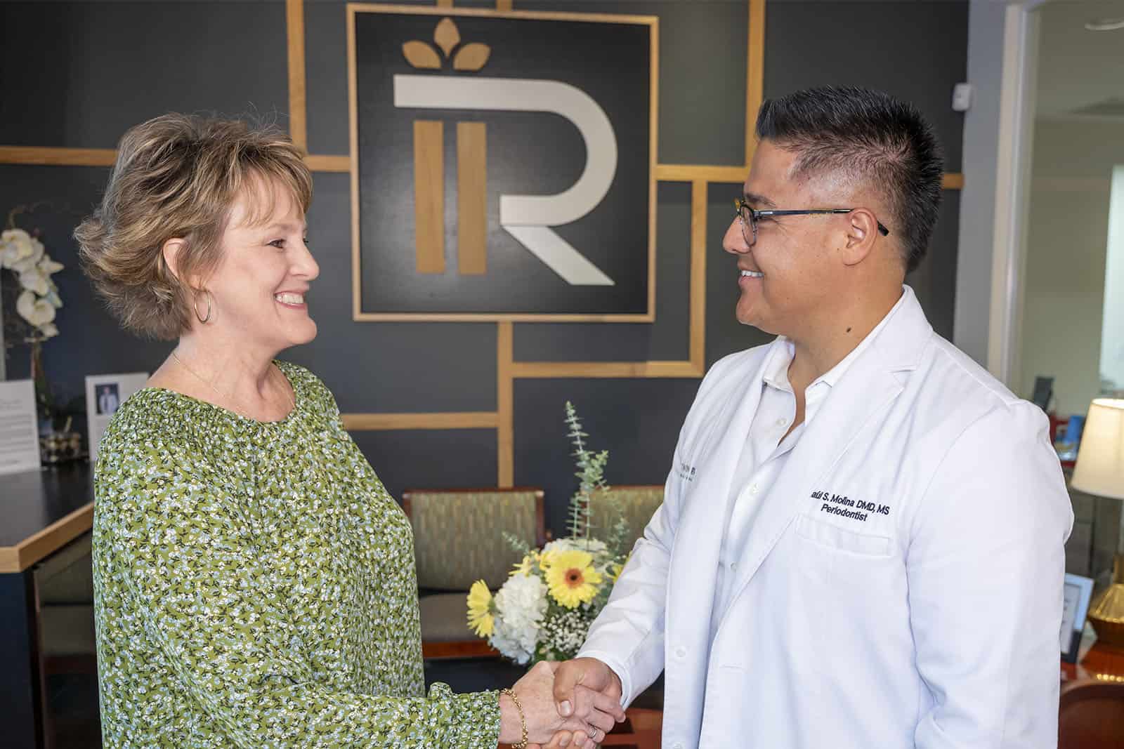 Dr. Molina shakes hands with a patient