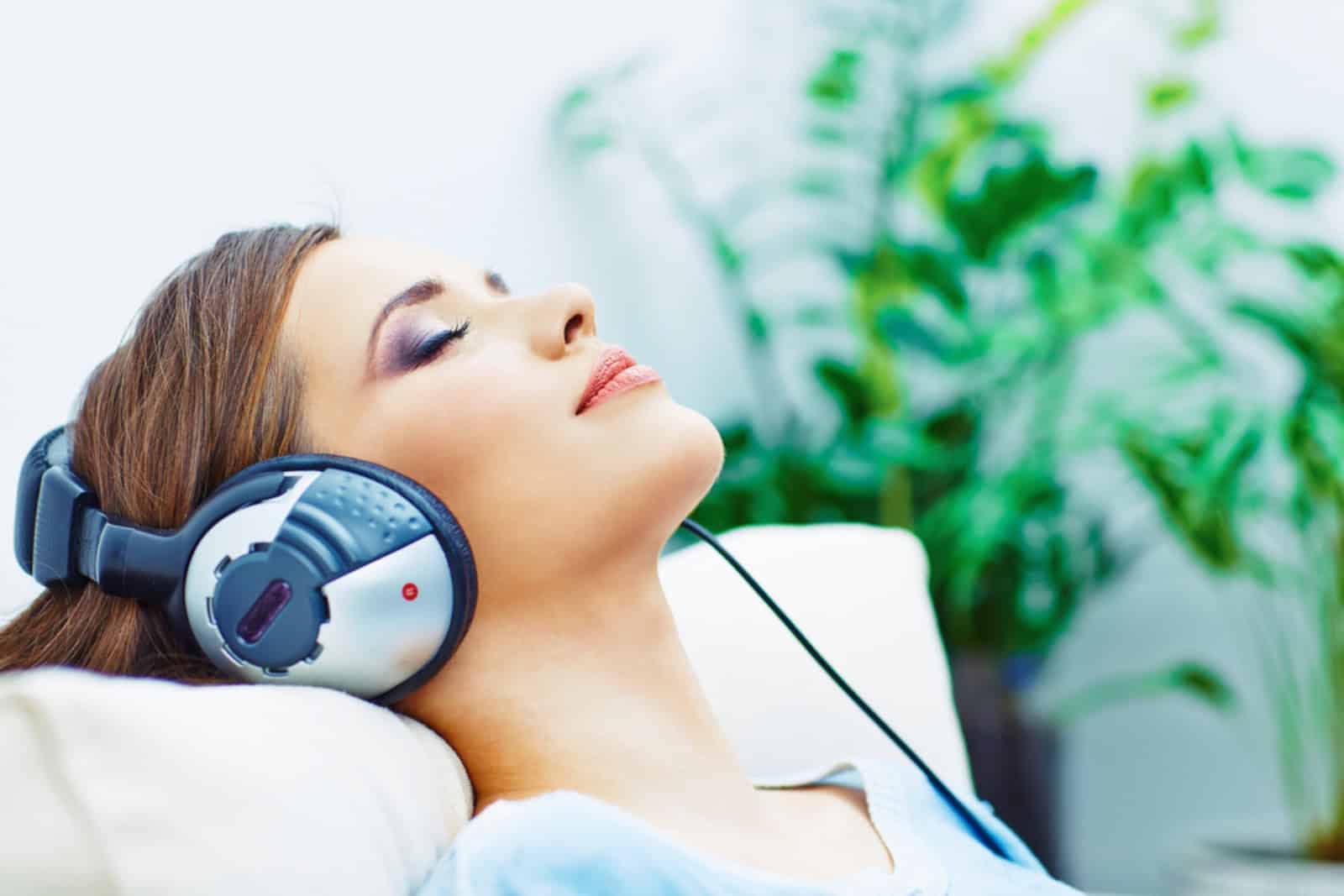A woman relaxing with her headphones on