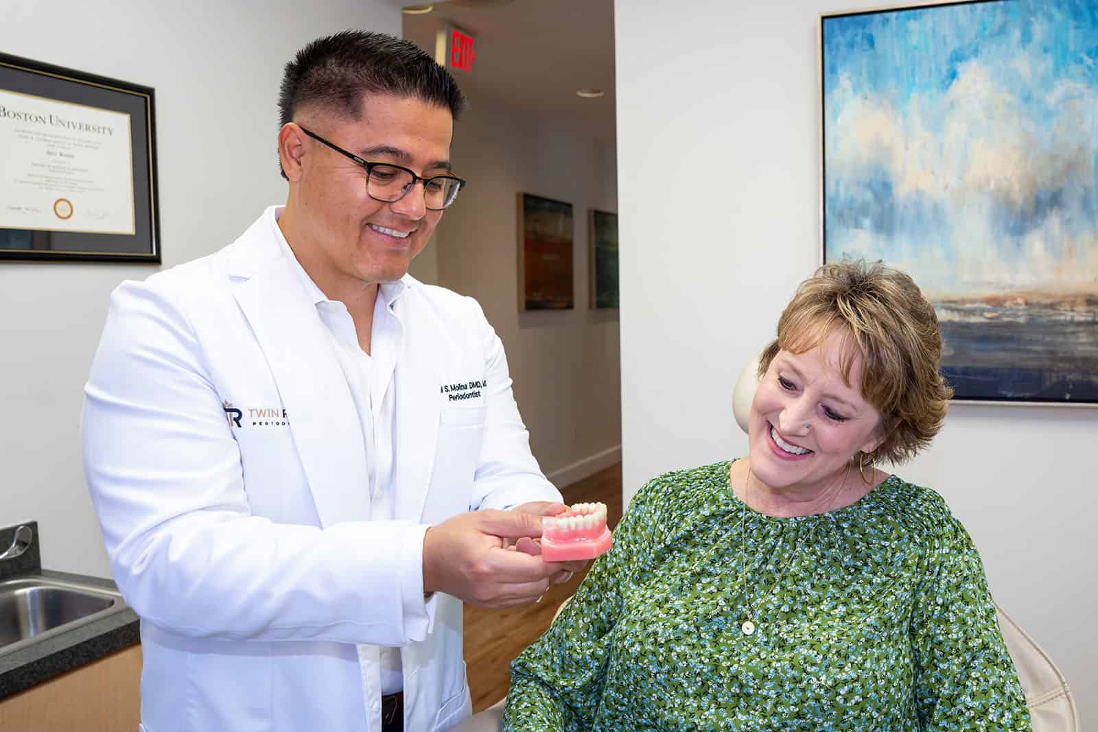 Dr. Molina shows a patient a 3D teeth model